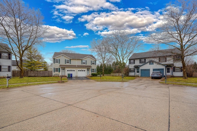 view of front of home with a front lawn, fence, and driveway