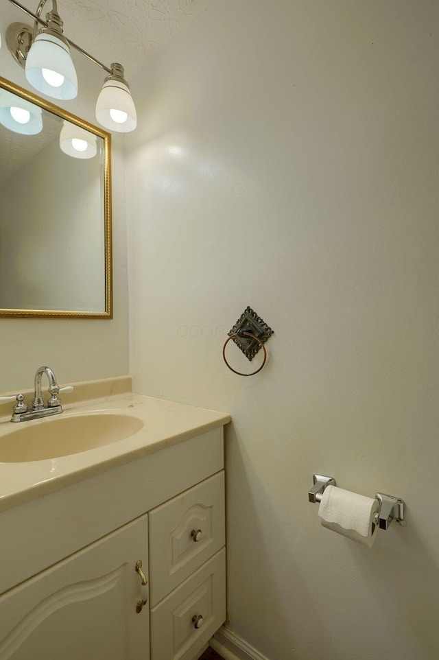 bathroom featuring a textured ceiling and vanity