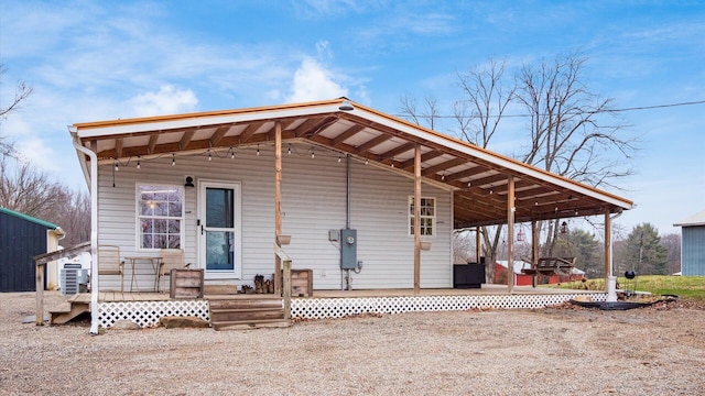 rear view of property with central AC unit