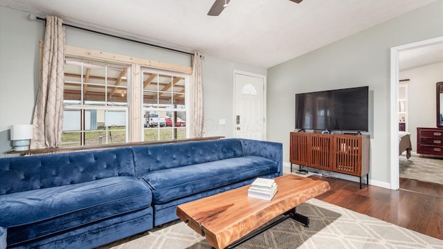 living room featuring wood finished floors, baseboards, and ceiling fan