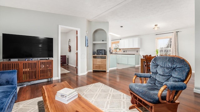 living area with wood finished floors and baseboards