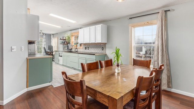 dining area with wood finished floors and baseboards