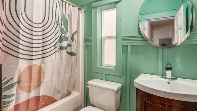 bathroom with shower / bath combination with curtain, toilet, and vanity