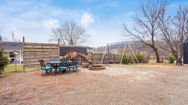 view of yard with fence and an outdoor fire pit