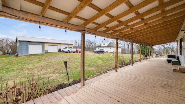 wooden deck featuring a yard, an outbuilding, and a garage