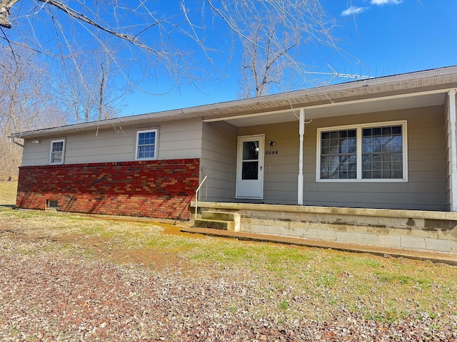 single story home with brick siding and covered porch