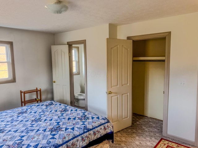 bedroom with a textured ceiling and carpet floors