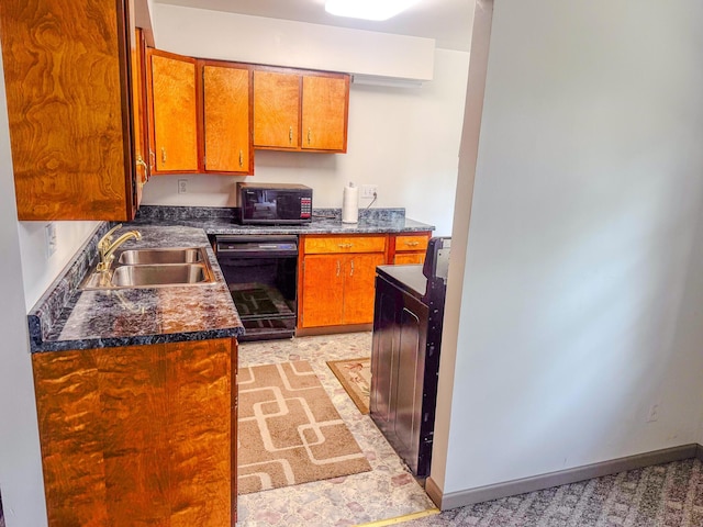 kitchen with brown cabinetry, baseboards, a sink, black appliances, and dark countertops