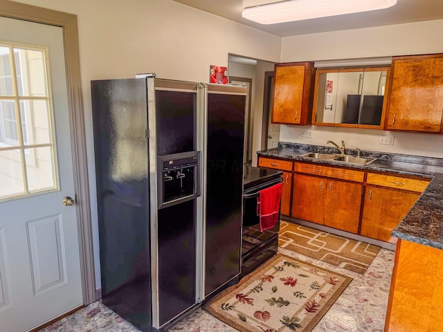 kitchen with electric stove, black fridge with ice dispenser, brown cabinets, and a sink