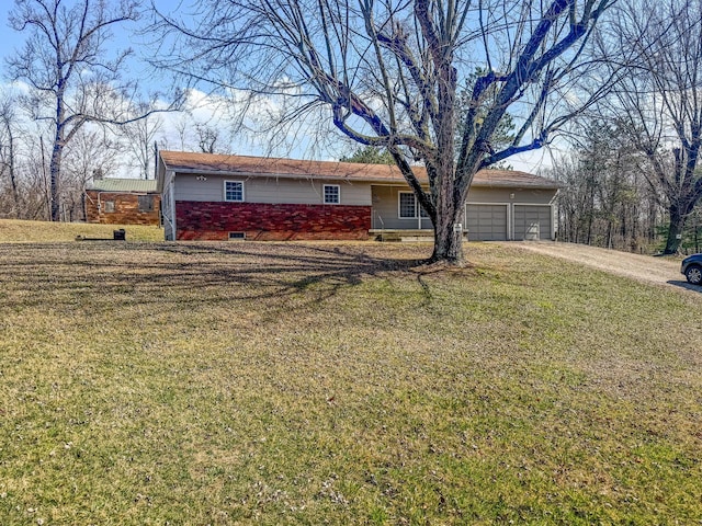 ranch-style home with driveway and a front lawn