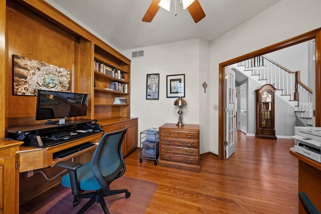 office space featuring visible vents, baseboards, a ceiling fan, and wood finished floors