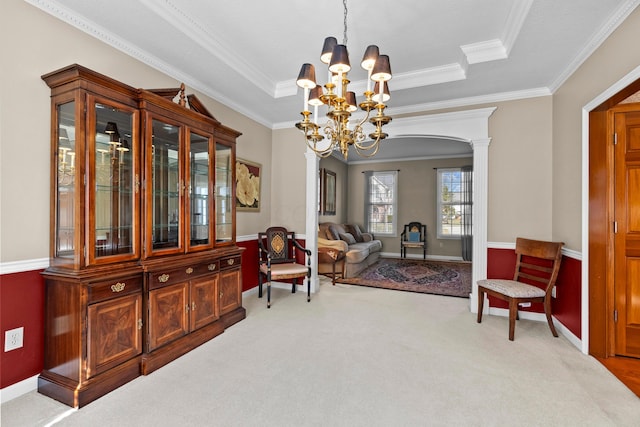 sitting room with a tray ceiling, a notable chandelier, ornamental molding, and carpet flooring