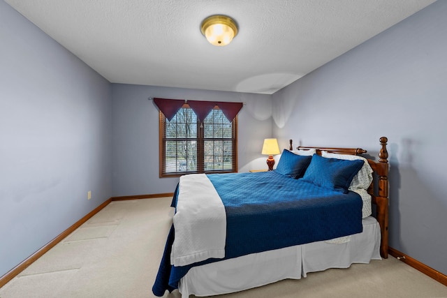 carpeted bedroom with baseboards and a textured ceiling