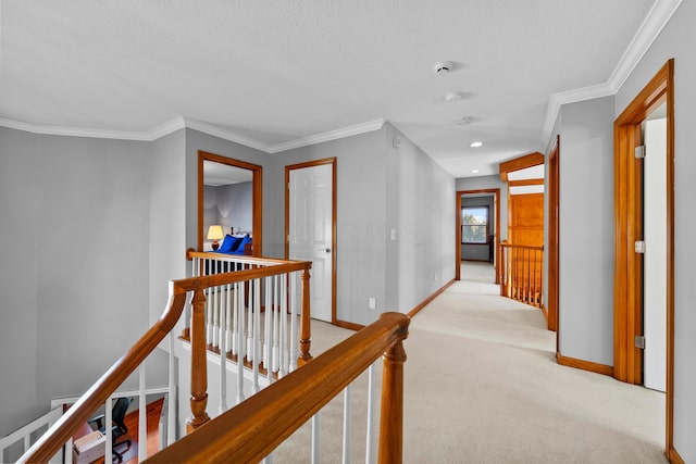 corridor with ornamental molding, an upstairs landing, baseboards, and light carpet