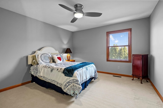 carpeted bedroom featuring visible vents, baseboards, and a ceiling fan