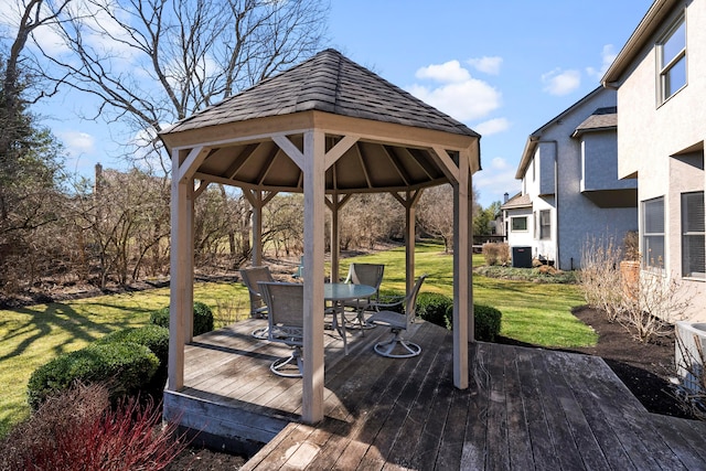 wooden terrace with a gazebo, central AC unit, outdoor dining area, and a yard