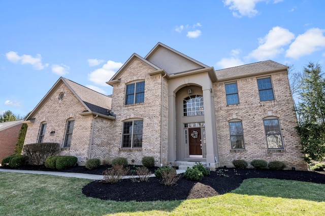 view of front of house featuring brick siding and a front lawn