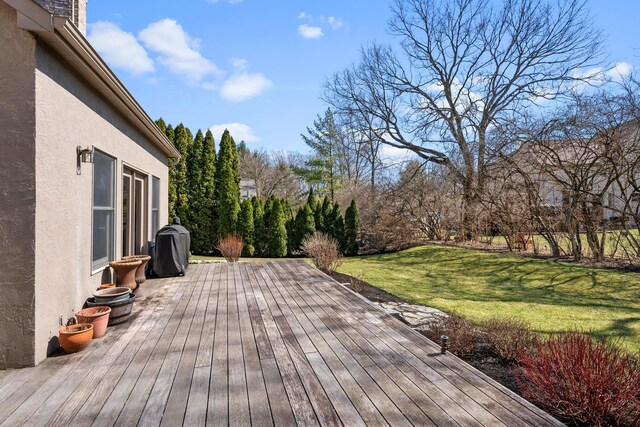 wooden deck featuring a yard