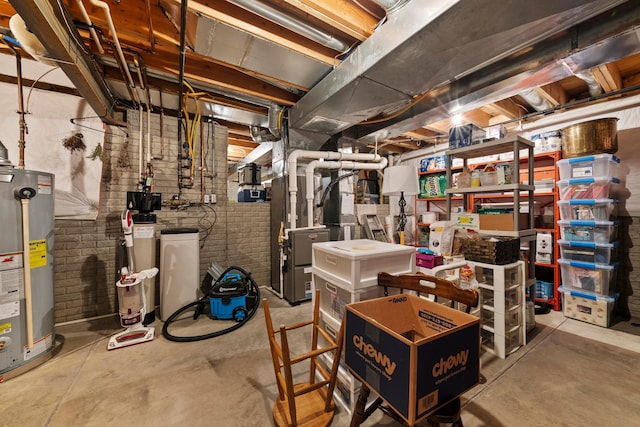 unfinished below grade area featuring brick wall and water heater