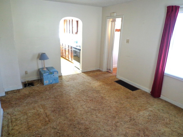 empty room with visible vents, carpet flooring, and baseboards