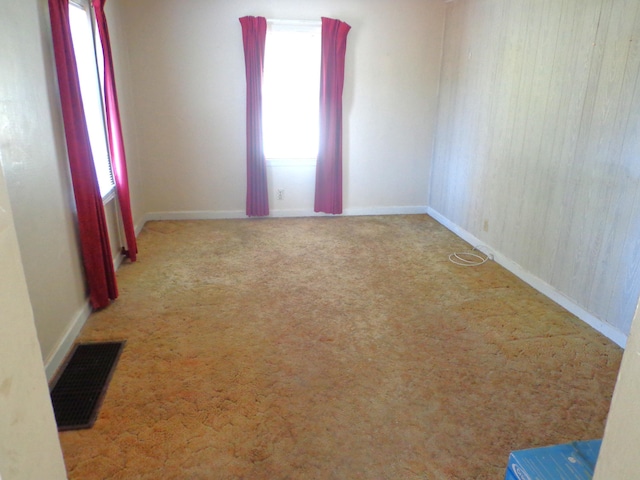 empty room featuring visible vents and carpet floors