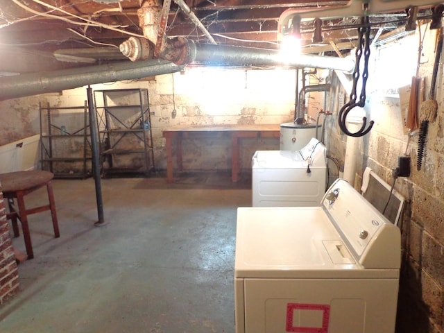 basement with gas water heater and washer and clothes dryer