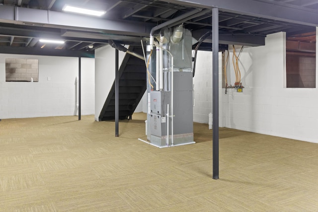 below grade area featuring heating unit and stairs
