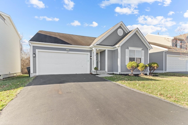 ranch-style house with a garage, a front yard, and driveway