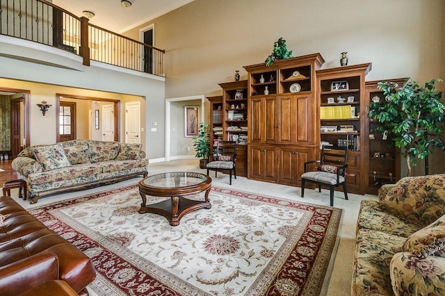 6884 Ballantrae Pl, Dublin, OH 43016 - living area with baseboards, light carpet, a high ceiling, and crown molding