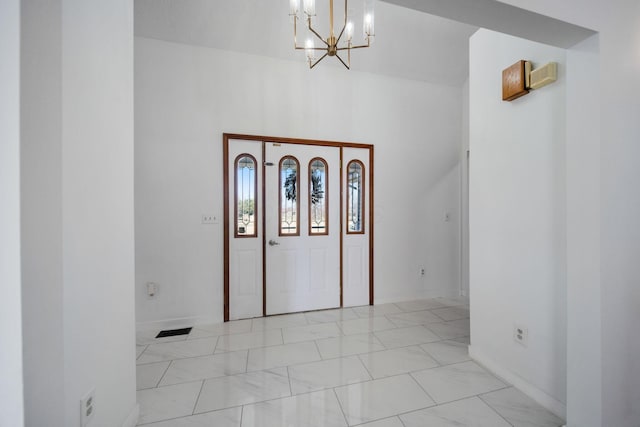 interior space featuring visible vents, baseboards, and a notable chandelier