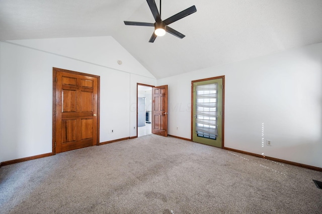 unfurnished bedroom with carpet flooring, visible vents, baseboards, and lofted ceiling