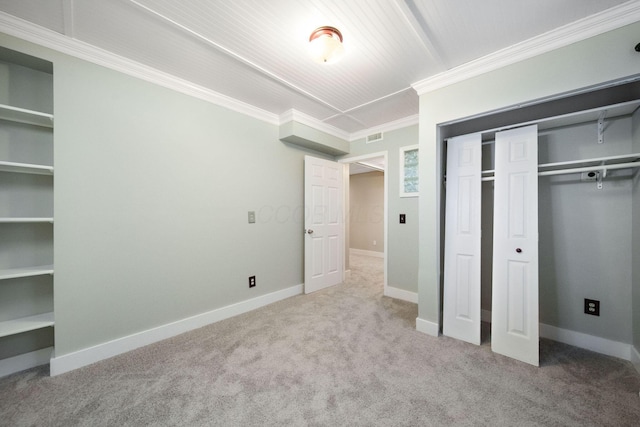 unfurnished bedroom featuring carpet, baseboards, a closet, and ornamental molding