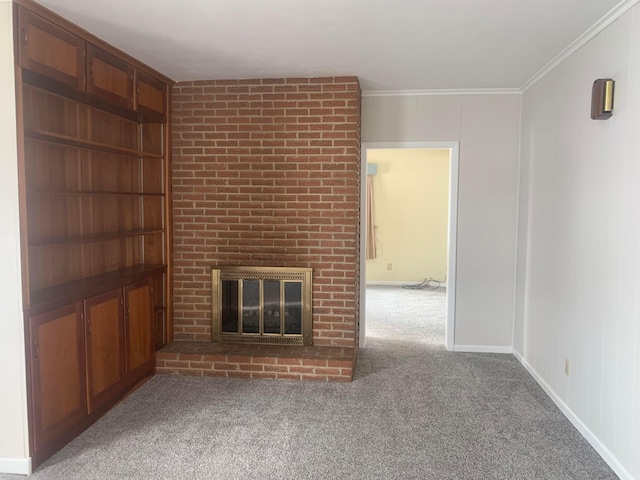 unfurnished living room with baseboards, carpet floors, ornamental molding, and a fireplace