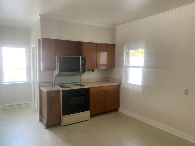 kitchen with light countertops, plenty of natural light, brown cabinetry, and range with electric stovetop