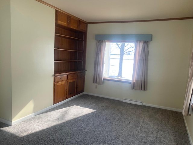 interior space with carpet flooring, visible vents, baseboards, and ornamental molding