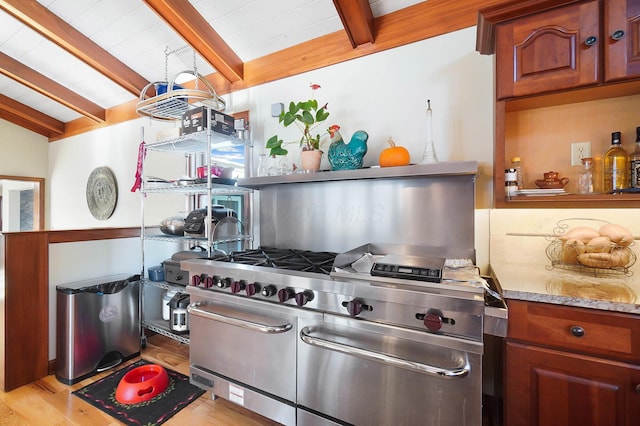 kitchen featuring vaulted ceiling with beams, light wood-type flooring, range with two ovens, decorative backsplash, and open shelves