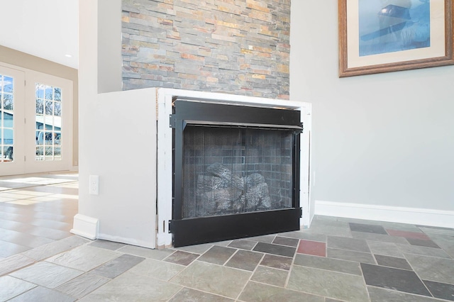 details featuring a fireplace and baseboards