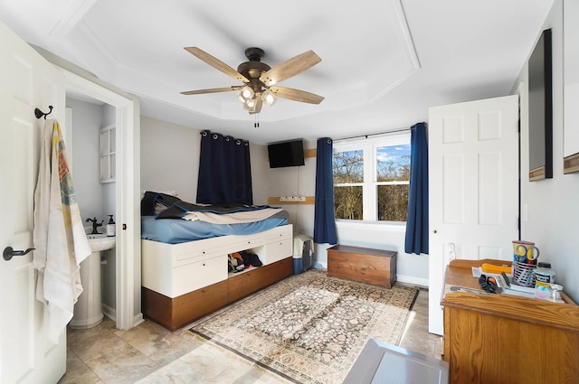 bedroom with baseboards, attic access, a raised ceiling, and ceiling fan