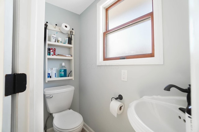 bathroom with toilet and a sink