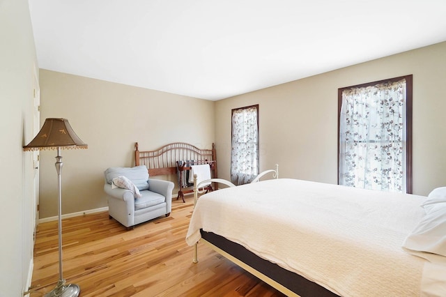 bedroom with baseboards and light wood-style floors