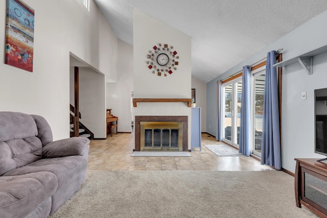 living room featuring a fireplace with flush hearth, a textured ceiling, carpet flooring, baseboards, and stairs