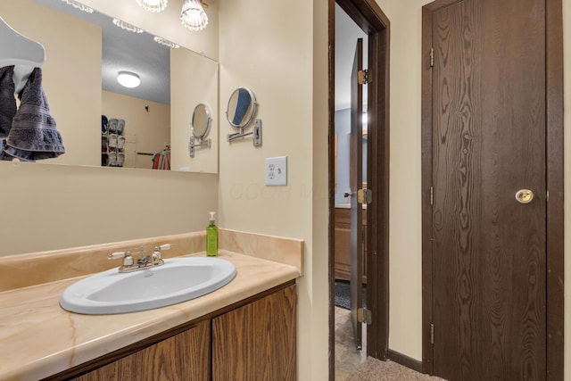 bathroom with vanity and a textured ceiling