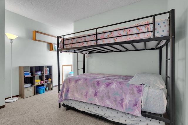 carpeted bedroom featuring a textured ceiling