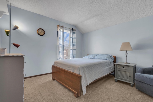 carpeted bedroom featuring baseboards, lofted ceiling, and a textured ceiling