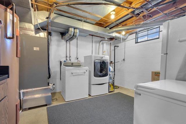 clothes washing area featuring washer and clothes dryer and laundry area