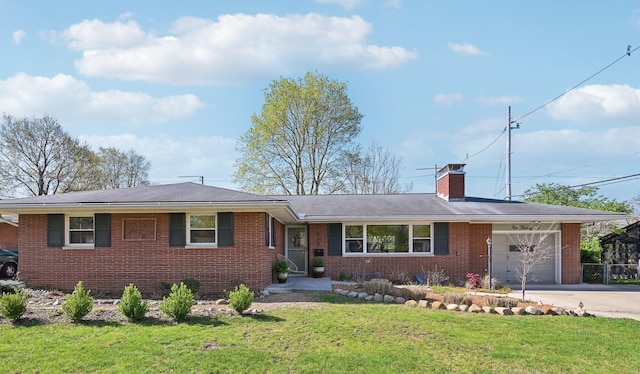 ranch-style home featuring a chimney, a front lawn, driveway, brick siding, and a garage