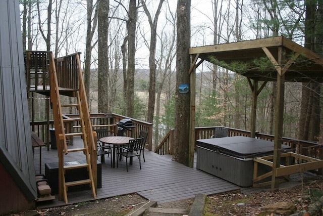 deck featuring outdoor dining area and a hot tub