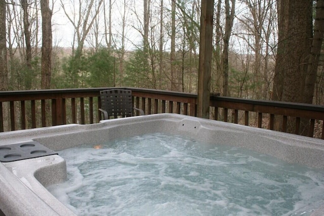 view of pool with a wooden deck and a hot tub