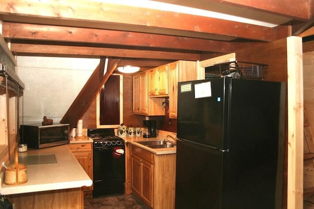 kitchen with beamed ceiling, black appliances, light countertops, and a sink