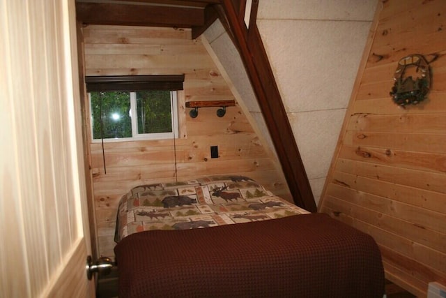 bedroom featuring wooden walls